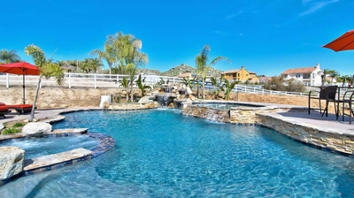 Backyard Pool with Spa and Waterfall Photo