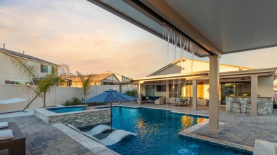 Water flowing into pool from waterfall overhead from patio Photo