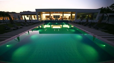 Modern open-air swimming area featuring dynamic lighting. Photo