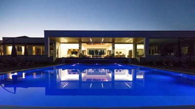 Cutting-edge open-air pool adorned with lighting effects and fire elements. Photo