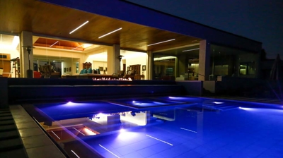 Stylish outdoor swimming spot with vibrant lighting and fiery highlights. Photo