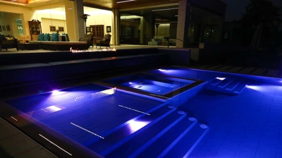 Trendy pool space with vibrant lighting effects. Photo