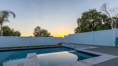 Backyard swimming pool and spa at sunset Photo