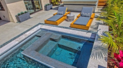 Overview of rectangle pool and lounging chairs Photo