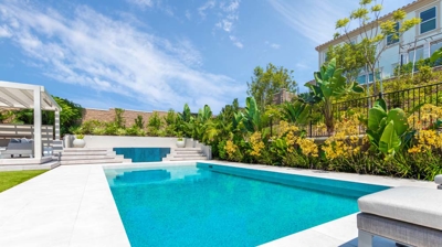 Rectangle pool design with jacuzzi in outdoor oasis Photo