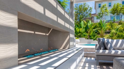 Patio section of outdoor backyard oasis with fireplace Photo