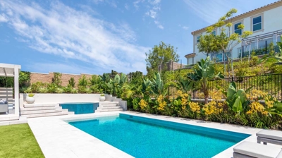 Rectangular pool with green grass on a sunny day Photo