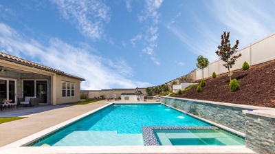 Overview of large rectangular pool and jacuzzi on a sunny day Photo