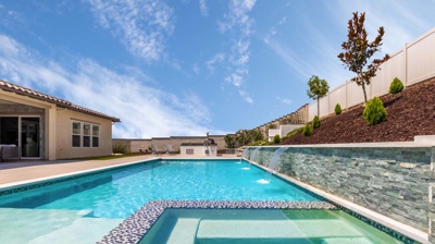 Overview of large rectangular pool and jacuzzi on a sunny day Photo