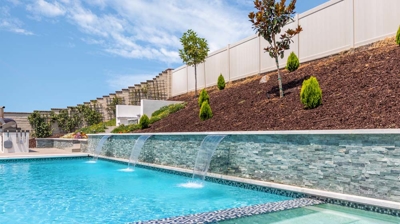 Overview of large rectangular pool and jacuzzi on a sunny day Photo