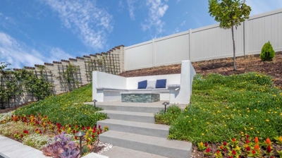 Flowers blooming around staircase within backyard area Photo