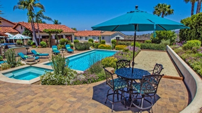 Overhead view of large pool and jacuzzi with lounging chairs on a sunny day Photo