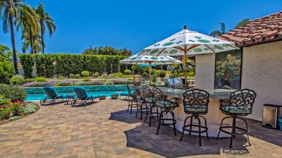 Overhead view of large pool and jacuzzi with lounging chairs on a sunny day Photo