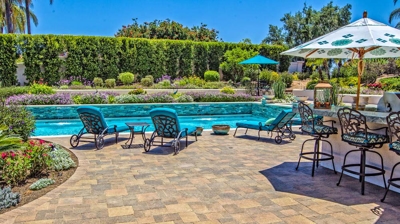 Patio area with lounging chairs and large pool Photo