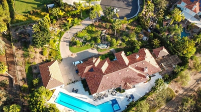 Aerial view of gorgeous home with large pool and lounge area Photo