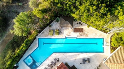 Aerial view of gorgeous home with large pool and lounge area Photo