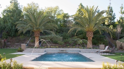 Backyard pool with water features Photo