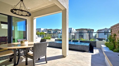 A daytime oasis with a rooftop on a modern patio next to dining area. Photo