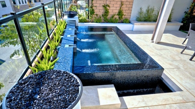 Sky-high spa retreat complemented by a fire pit and charming potted flora. Photo