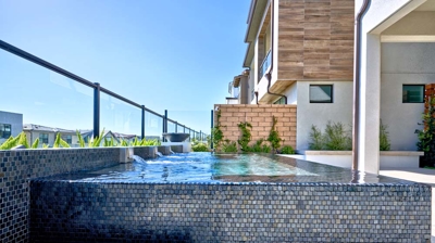 Elevated wellness destination offering a spa, fire pit, and delightful potted plant accents. Photo