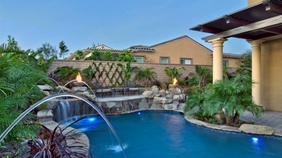 Backyard pool with water features Photo