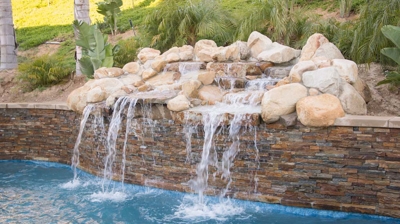 Pool with rock waterfall fountain Photo