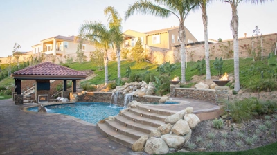 Outdoor pool with staircase going to attached spa Photo