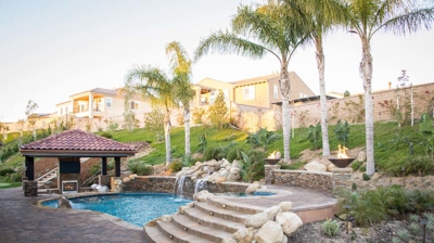 Outdoor pool with staircase going to attached spa Photo
