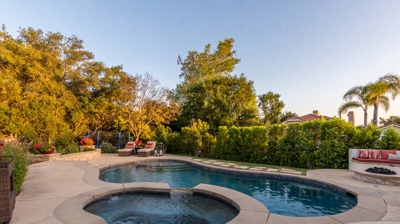Backyard pool with attached spa Photo