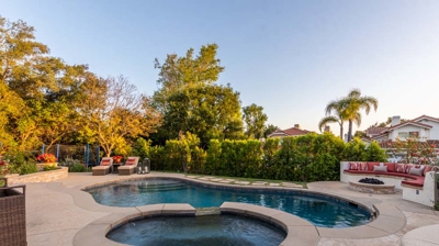 Beautiful backyard with pool and attached spa Photo