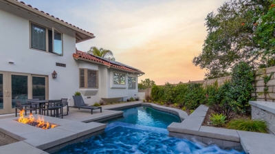 Backyard spa next to fire feature at sunset Photo