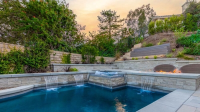 Pool with water features and attached spa Photo