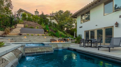 Backyard pool with wall water features Photo