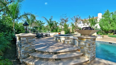 Staircase going to the attached spa for the pool Photo
