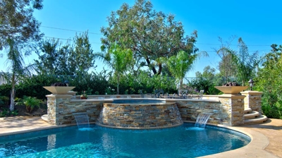 Backyard pool and spa with water features Photo