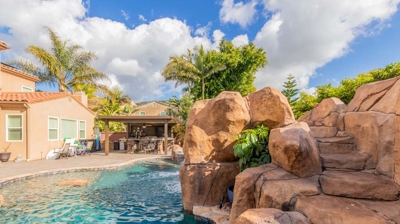A symphony of water: curved pool, hot tub, and captivating waterfall Photo