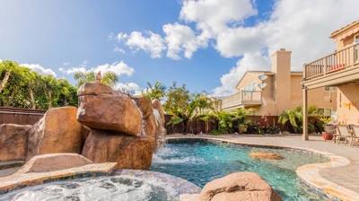 Oasis of calm: curved pool, hot tub, and soothing waterfall in perfect harmony Photo