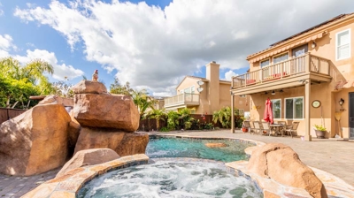 Serenity captured: a curved pool complemented by a hot tub and waterfall Photo