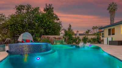 A serene oasis: oval pool and hot tub bathed in soft twilight lighting Photo
