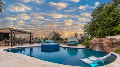 Elegant evening ambiance: oval pool and hot tub glowing in the dusk Photo