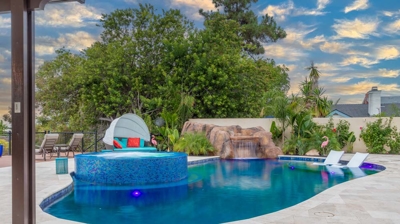 Tranquil retreat: oval pool and hot tub illuminated by nightfall Photo
