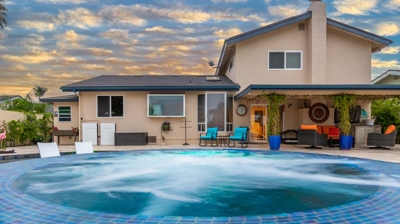 Enchanting scene of a softly lit oval pool and hot tub at dusk Photo