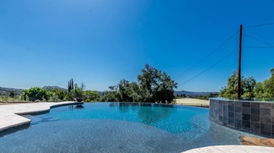 Crystal-clear water in a pool, bordered by smooth, curved edges. Photo