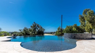 a sunlit pool with smooth edges beckoning for a swim Photo