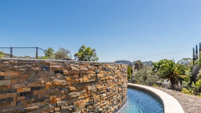 a pool's curved edges enhancing its sunny charm Photo