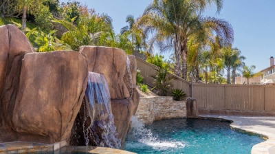A picturesque scene of a pool, hot tub, and waterfall creating a tranquil oasis Photo