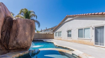 An idyllic setting with a pool, hot tub, and cascading waterfall, perfect for relaxation Photo