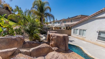A luxurious pool and hot tub complemented by the soothing sound of a waterfall Photo