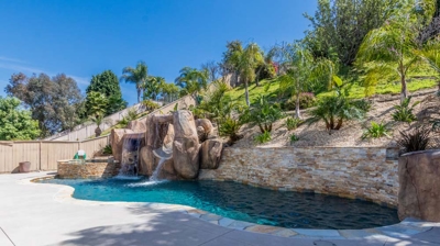 A blissful retreat with a pool, hot tub, and natural waterfall setting Photo