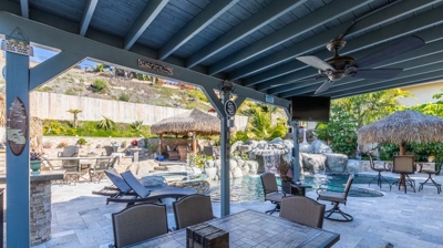 Tropical-inspired outdoor seating area with colorful tiki accents Photo